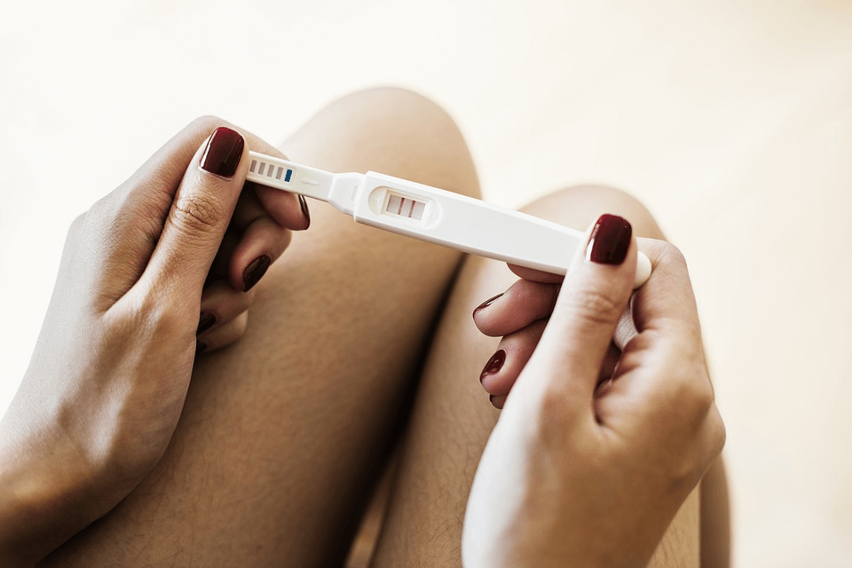 new-mom-holding-positive-pregnancy-test